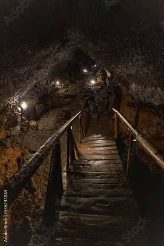 Exploring a volcanic cave in the Volcanic Caves Park at the foot of Villarrica volcano in Pucon, Chile 