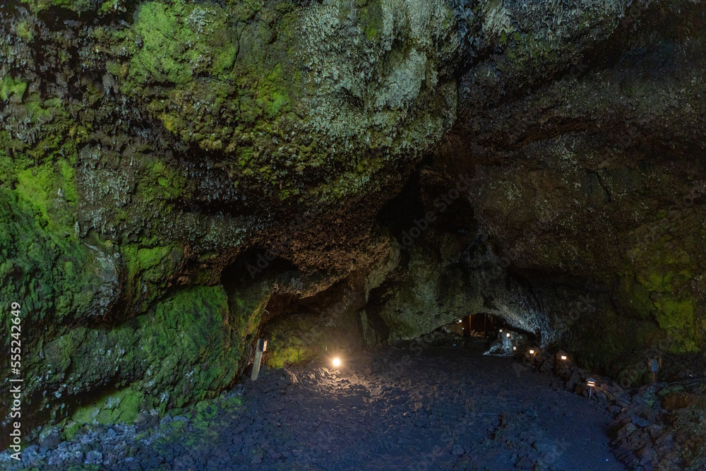 Obraz premium Exploring a volcanic cave in the Volcanic Caves Park at the foot of Villarrica volcano in Pucon, Chile 