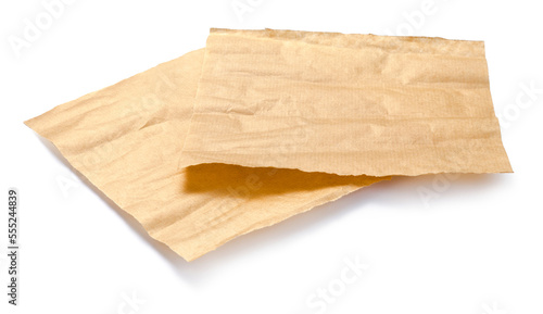Baking paper isolated. Crumpled pieces of brown parchment or baking paper on white background. Design element. photo