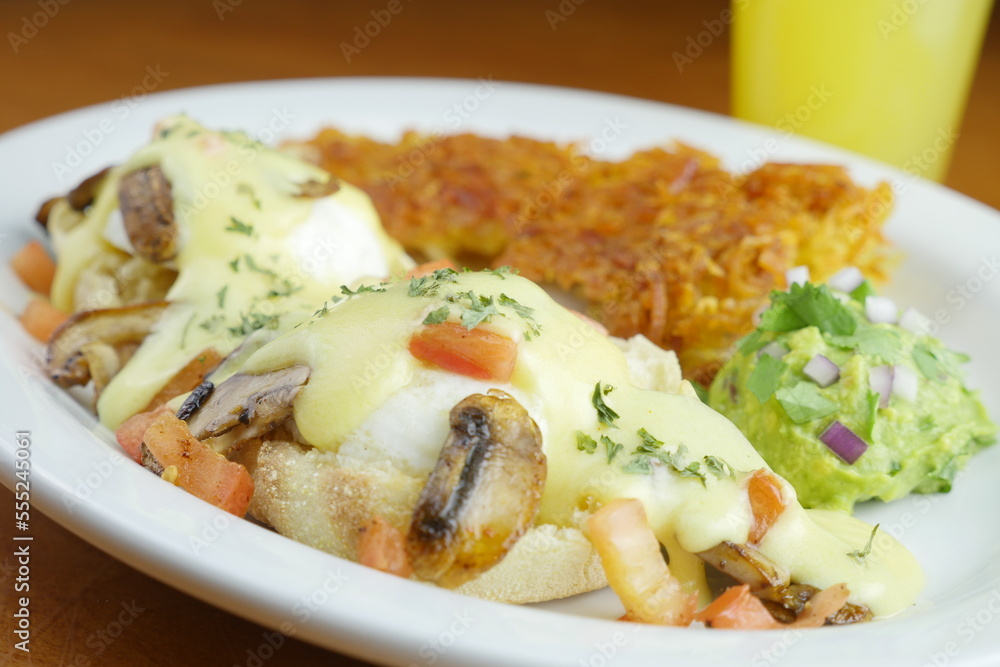 Restaurant plated breakfast burrotio with glass of orange juice Restaurant plated breakfast burrotio with glass of orange juice