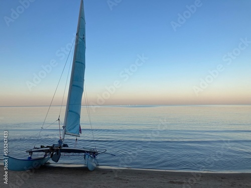 sailboat at the beach during sunset