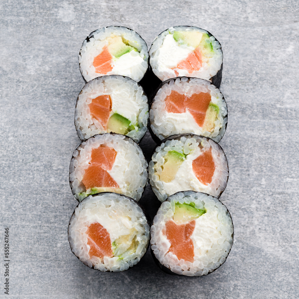 Traditional Japanese cuisine sushi rolls with salmon, avocado and cream cheese. Traditional Japanese cuisine sushi rolls with salmon, avocado and cream cheese.