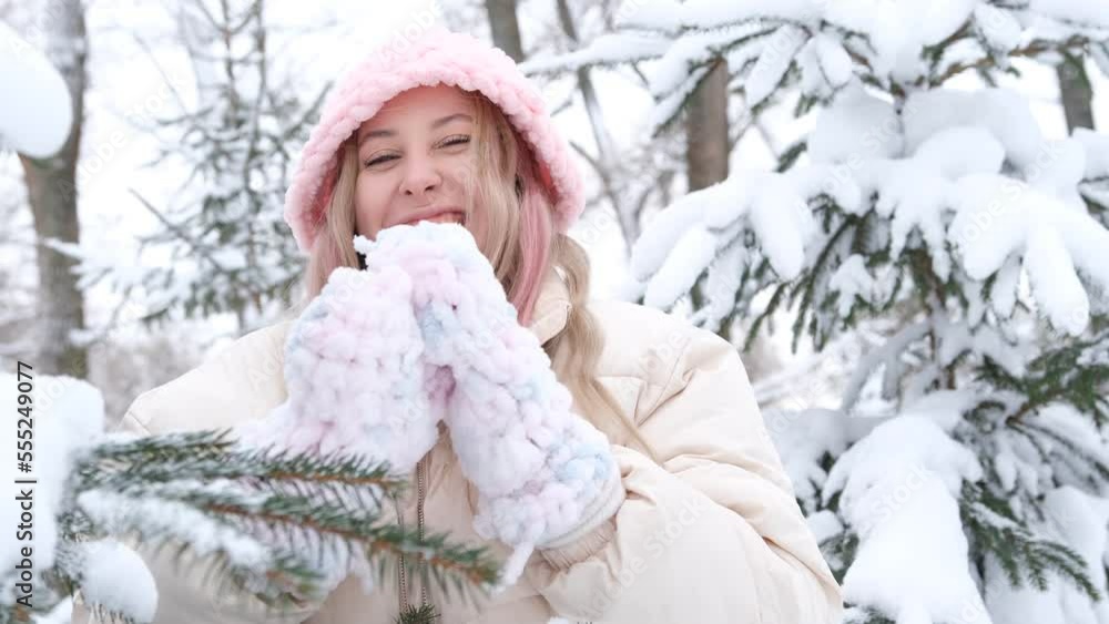 Portrait of happy beautiful girl, young joyful positive woman walking playing with snow, snowflakes, having fun outdoors in winter clothes, hat and scarf, smiling. Winter season, weather. Portrait of happy beautiful girl, young joyful positive woman walking playing with snow, snowflakes, having fun outdoors in winter clothes, hat and scarf, smiling. Winter season, weather.