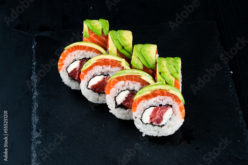 Set of sushi rolls with tuna, salmon, cream cheese and avocado.