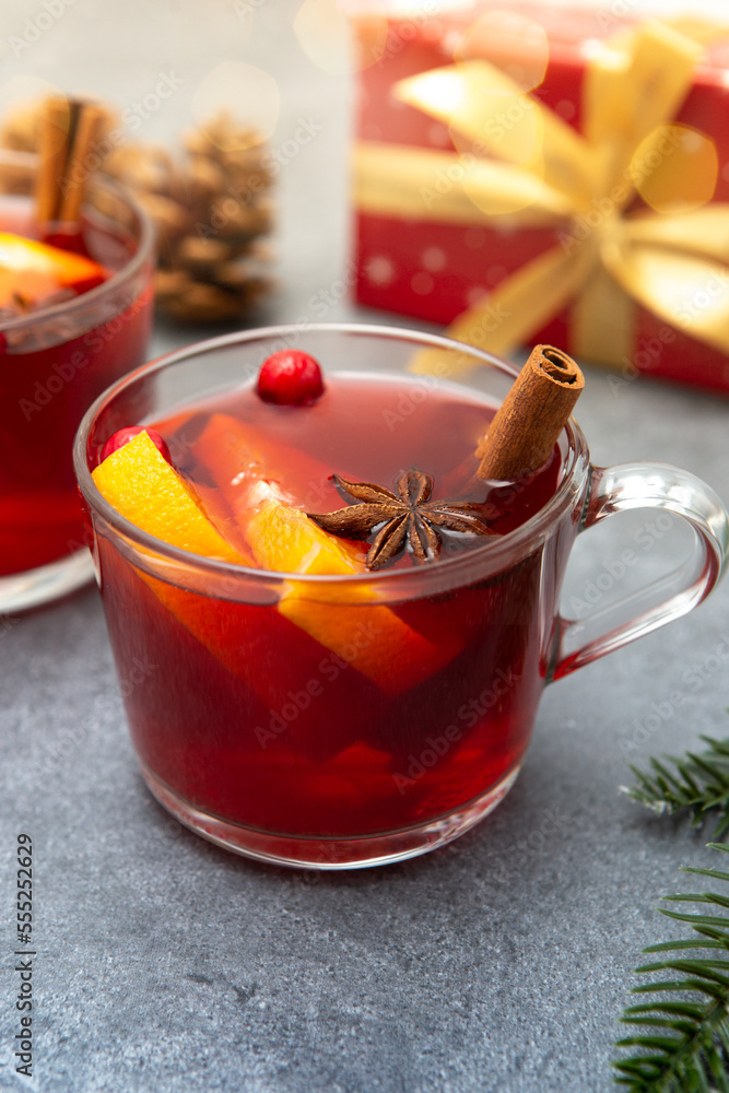 Two cups of christmas mulled wine or gluhwein with spices and orange slices on rustic table top view. Two cups of christmas mulled wine or gluhwein with spices and orange slices on rustic table top view.
