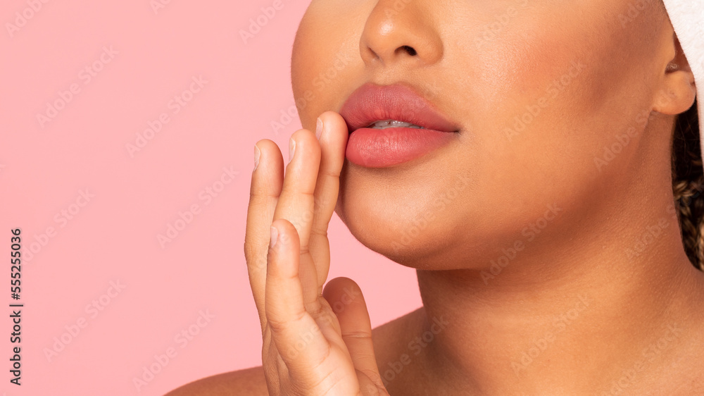 Fototapeta premium Lips care concept. Sensual black chubby lady with smooth skin touching her beautiful soft lips, copy space