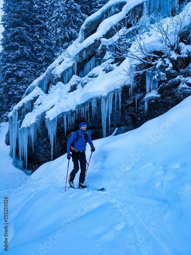 Ski tour under a frozen waterfall in the swiss alps. Ski mountaineering in winter. Silberen Glarus Uri photo