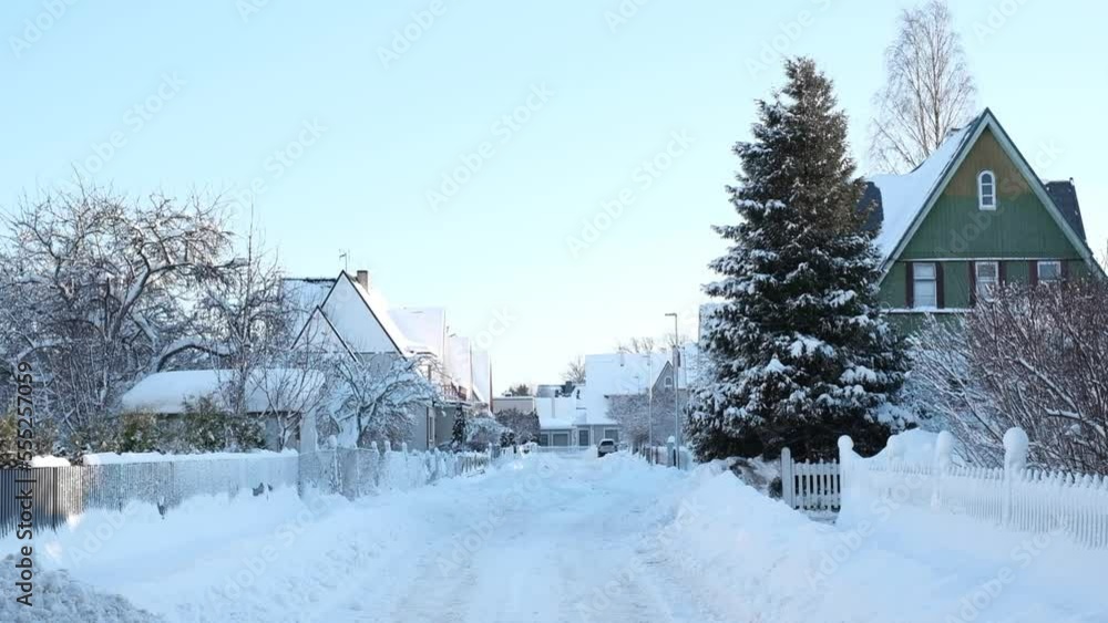 Winter fairy-tale landscape on the street with houses with a triangular roof and roads covered with a lot of snow Winter fairy-tale landscape on the street with houses with a triangular roof and roads covered with a lot of snow