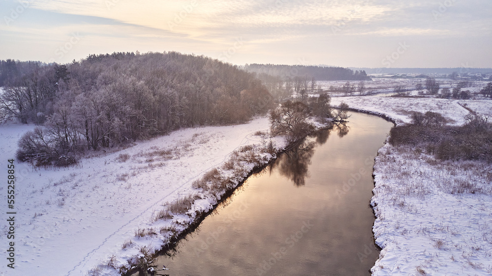 Winter river landscape, snow covered fields. Hoarfrost on trees, plants. Frosty morning. Sunny cloudy Misty weather. Cold season. Calm nature scene