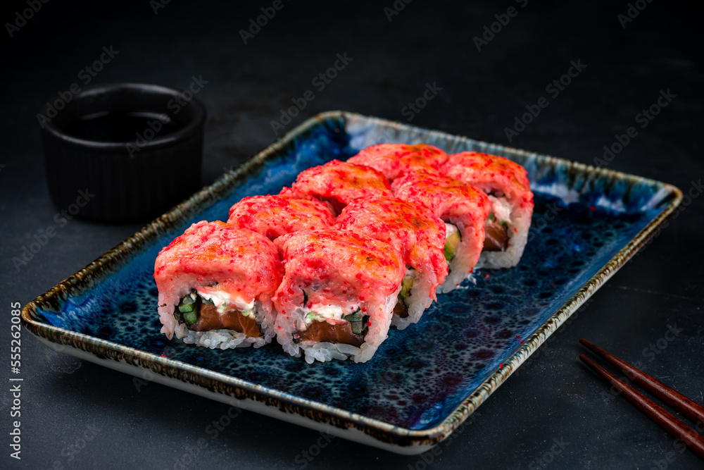 Set of sushi rolls with tuna tartare, salmon, cream cheese, avocado, cucumber, red flying fish caviar and soy sauce. Set of sushi rolls with tuna tartare, salmon, cream cheese, avocado, cucumber, red flying fish caviar and soy sauce.
