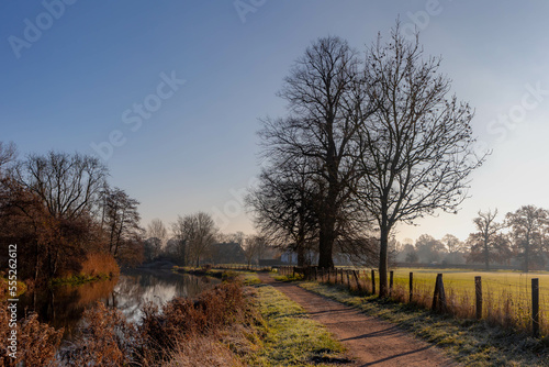 Winter landscape view of white frost in morning, Nature path along the Kromme Rijn river (Crooked Rhine) in Rhijnauwen, Bunnik is a municipality and a village in the province of Utrecht Netherlands. photo