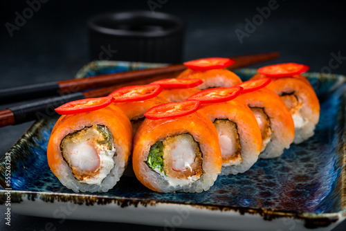 Japanese cuisine set of sushi rolls with shrimp tempura, cream cheese, lettuce, cheddar cheese and chili peppers.