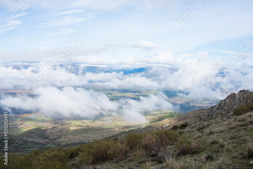 Beautiful landscape from a hill top. Low clouds over the valley