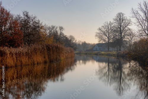 Winter landscape view of white frost in morning, Nature path along the Kromme Rijn river (Crooked Rhine) in Rhijnauwen, Bunnik is a municipality and a village in the province of Utrecht Netherlands. © Sarawut