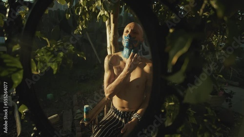 Mexica Aztec Dancer painting his face 