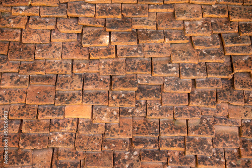 Medieval tiled roof made of handmade clay tiles as texture or background