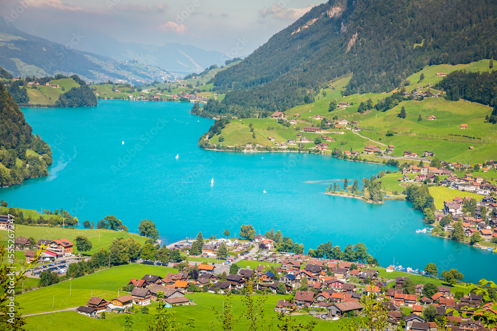 Turquoise Lungernsee and village lungern in the Swiss Alps, Switzerland