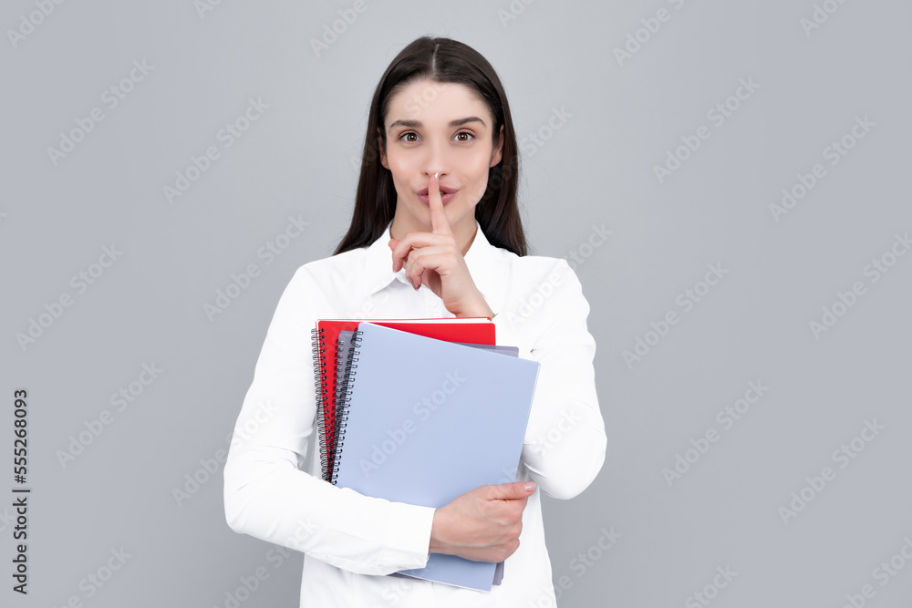 Teen girl with notebooks standing over gray background with copy space. Educational concept for school. Portrait of young student. Teen girl with notebooks standing over gray background with copy space. Educational concept for school. Portrait of young student.