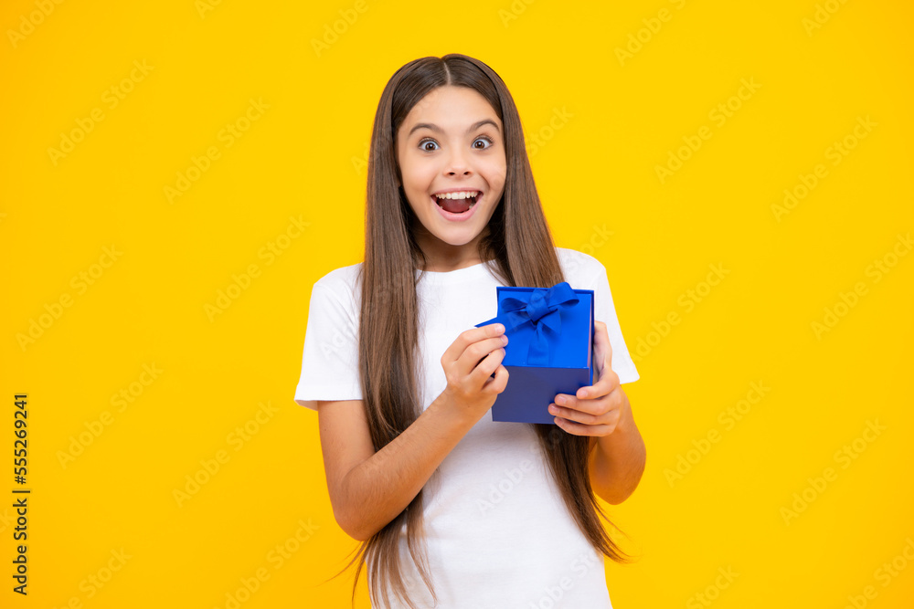 Teenager child with gift box. Present for holidays. Happy birthday, Valentines day, New Year or Christmas. Kid hold present box. Excited teenager, glad amazed and overjoyed emotions. Teenager child with gift box. Present for holidays. Happy birthday, Valentines day, New Year or Christmas. Kid hold present box. Excited teenager, glad amazed and overjoyed emotions.
