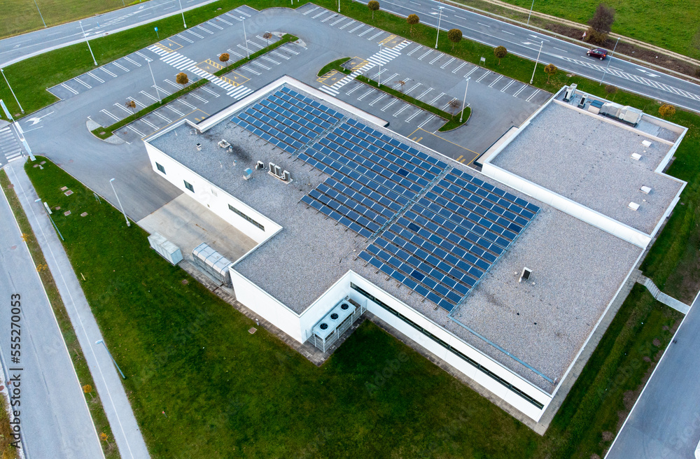 Array of solar panels on the roof of a commercial building top down ...
