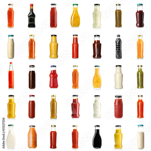 Group of tasty sauces in bottles on white background