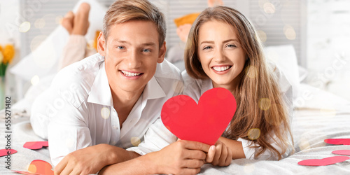 Happy young couple with red...