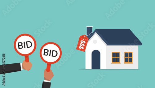 Businessmen hold bid signs for auction a house, buyers place bids, auction and bidding concept photo