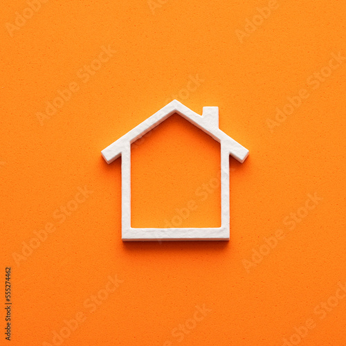 Investment concept for home purchase - White house on orange foamy