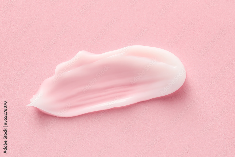 Sample of moisturizing cream on pink background