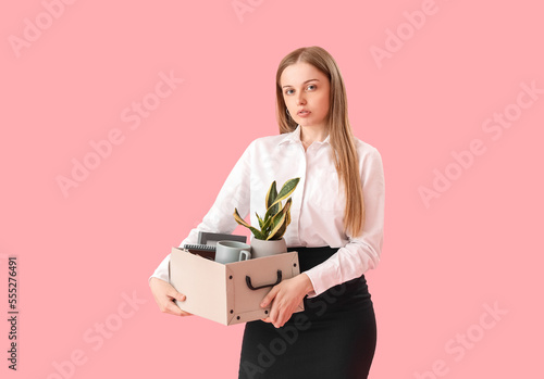 Fired young woman holding b...