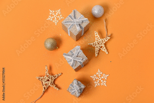 Beautiful Christmas gifts and decorations on color background