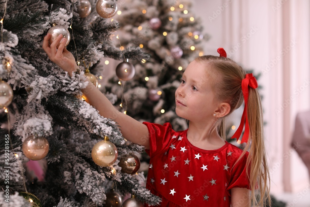 Cute little child near Christmas tree at home Cute little child near Christmas tree at home