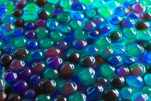 Hydrogel Orbeez background.multicolored orbiz texture.Blue green orbiz balls in water.Hydrogel balls for decoration, gardening and air humidifier.Beautiful background in cool blue and green colors photo