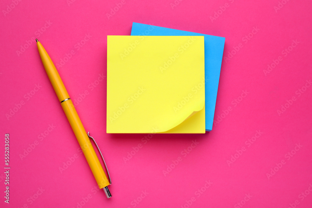 Colorful empty notes and pen on pink background, flat lay Colorful empty notes and pen on pink background, flat lay