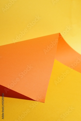Bright orange paper sheet on yellow background