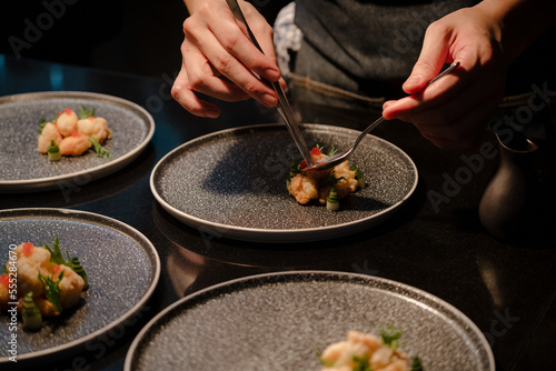 Fototapete Close up of a chef's hand cooking and preparing fine dining meals