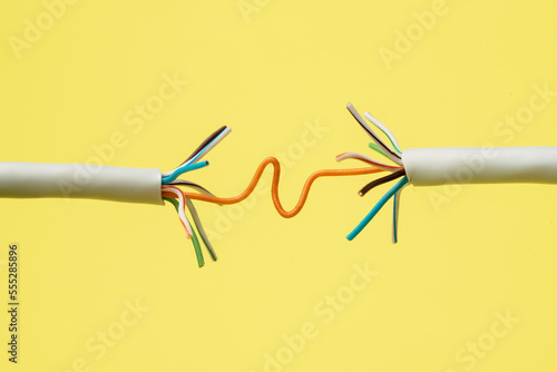 Network connection, internet connection and computer technology concept, close-up of ethernet cable connector, on yellow background © Aleksandr