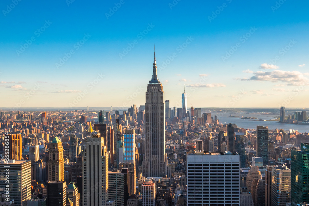 Panoramic view of The Empire State Building, Manhattan downtown and skyscrapers at sunset.