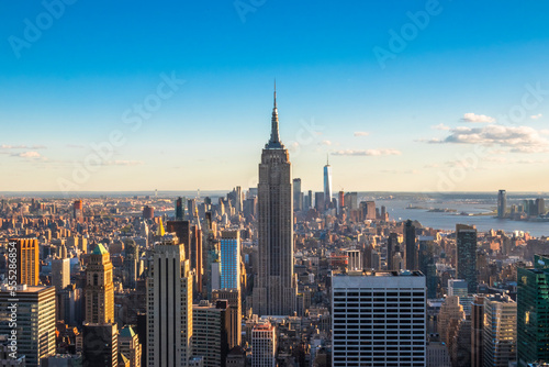 Panoramic view of The Empire State Building, Manhattan downtown and skyscrapers at sunset.