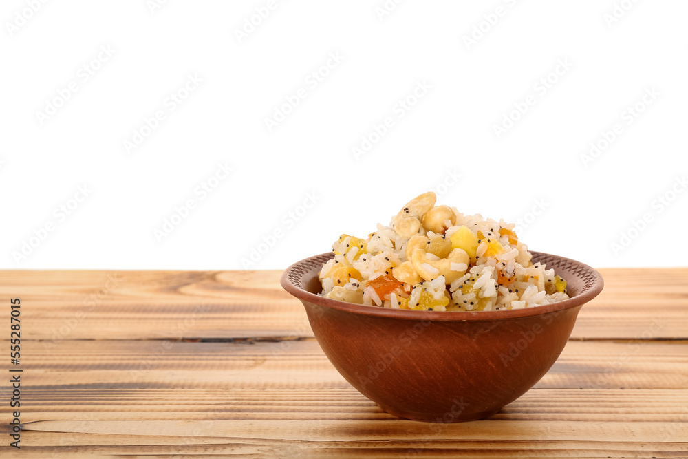Bowl of rice Kutya on table against white background Bowl of rice Kutya on table against white background