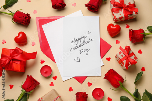 Card with text HAPPY VALENTINE'S DAY, gifts, roses and hearts on beige background