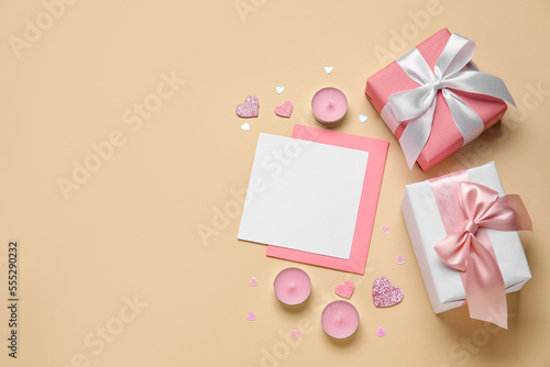 Blank letter with candles and gifts on beige background. Valentine's Day celebration © Pixel-Shot