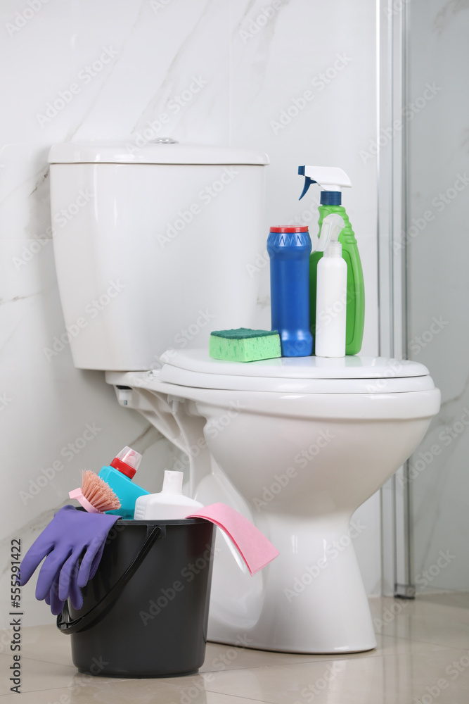 Cleaning supplies and toilet bowl in bathroom Cleaning supplies and toilet bowl in bathroom