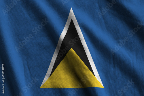 Saint Lucia flag with big folds waving close up under the studio light indoors. The official symbols and colors in fabric banner photo