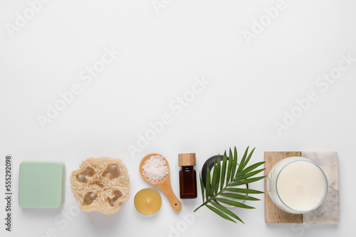 Flat lay composition with different spa products on white background, space for text