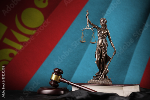 Mongolia flag with statue of lady justice, constitution and judge hammer on black drapery. Concept of judgement and punishment photo
