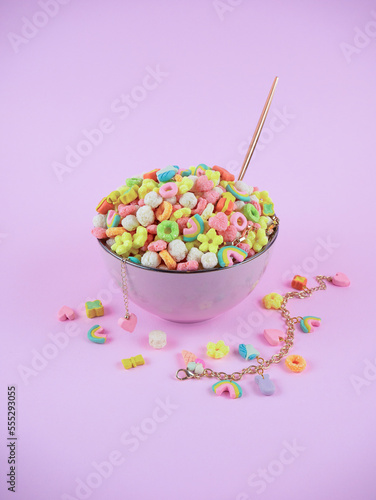 Plate with colorful cereals and gold decorations on a purple background