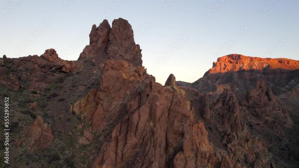 Aerial View Of Red Rock Cliffs With Sparse Vegetation At Teide National Park. Ascending Shot Aerial View Of Red Rock Cliffs With Sparse Vegetation At Teide National Park. Ascending Shot