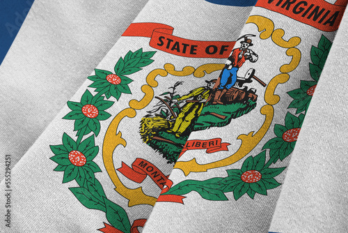 West Virginia US state flag with big folds waving close up under the studio light indoors. The official symbols and colors in fabric banner photo