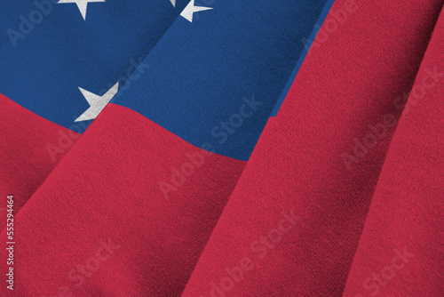 Samoa flag with big folds waving close up under the studio light indoors. The official symbols and colors in fabric banner photo